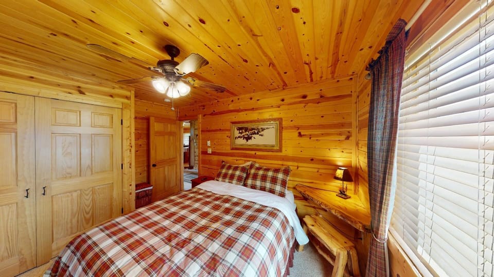 This bedroom is on the main floor and has a cozy atmosphere. The room features a desk that can be used for a plethora of everyday needs, as well as a T.V. to help foster relaxation after a long day of adventures.