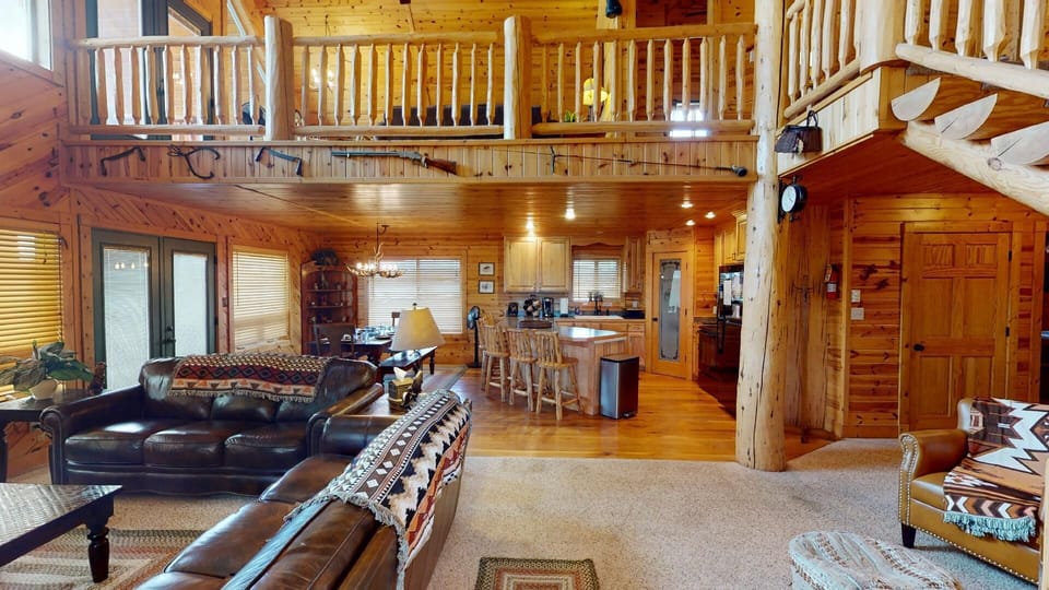 View from the main entrance that features a view of the kitchen/dining area, and the living room while highlighting the tall ceilings that allow the space to feel grand and open.
