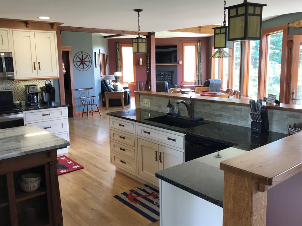 View from beautiful kitchen into living room and large dining area.