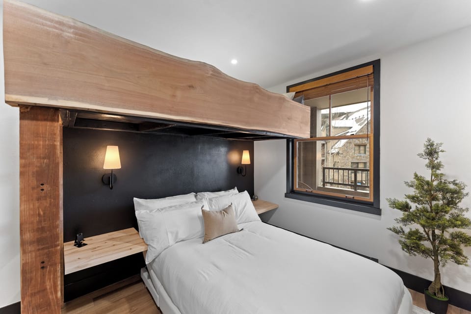 The guest bedroom features a twin over full bunk bed and mounted TV.