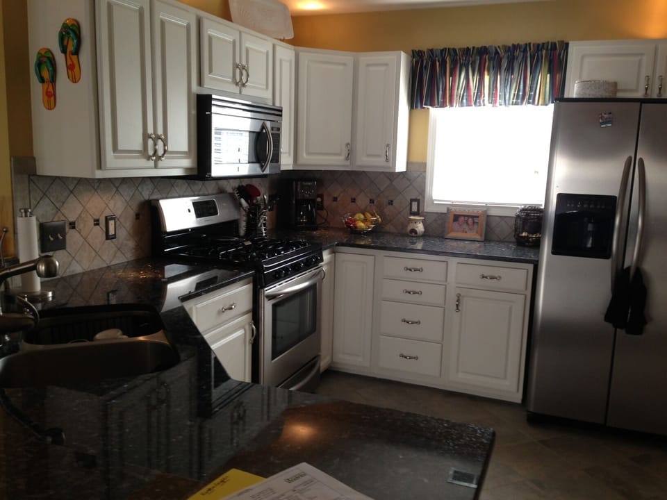 Another view of the updated, fully stocked kitchen.