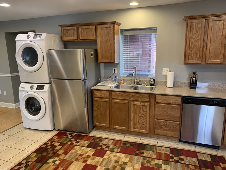 Kitchen area including washer and dryer.