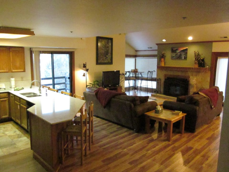 View of kitchen, informal dining and living room areas