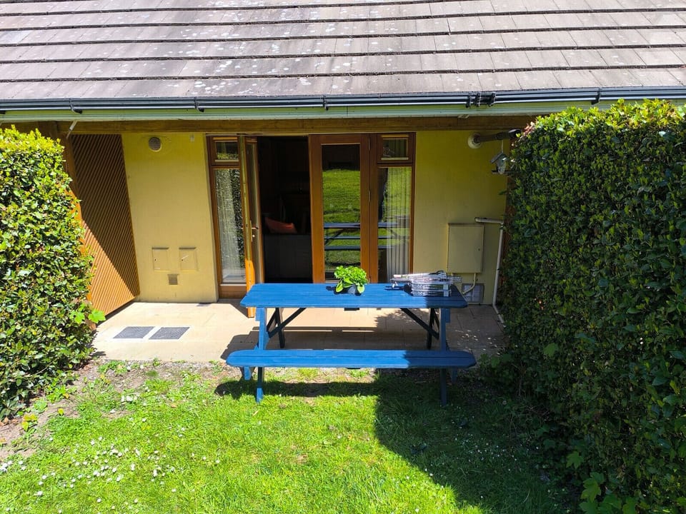 Heyward Mews Holiday Homes. Patio access to private sunny garden. Garden table and bench.