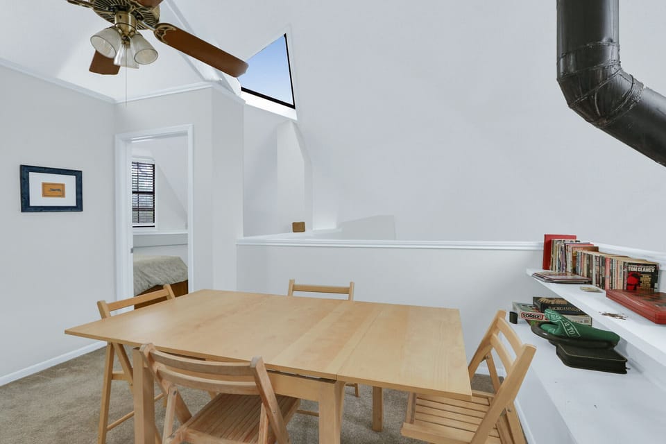 There is a table and games in the loft up the stairs, the third bedroom is through the door on the left