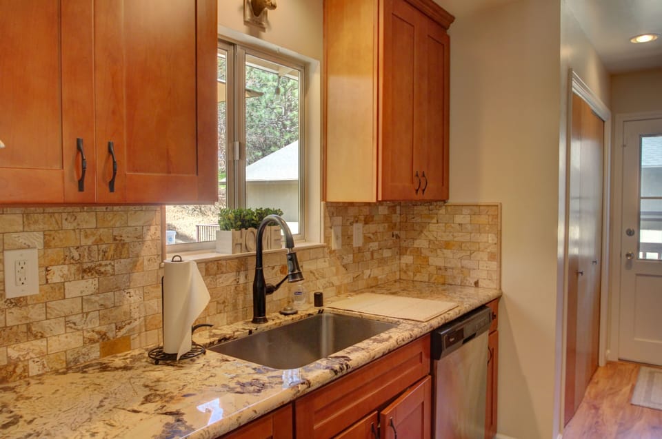 Newly remodeled kitchen with large stainless steel sink. 