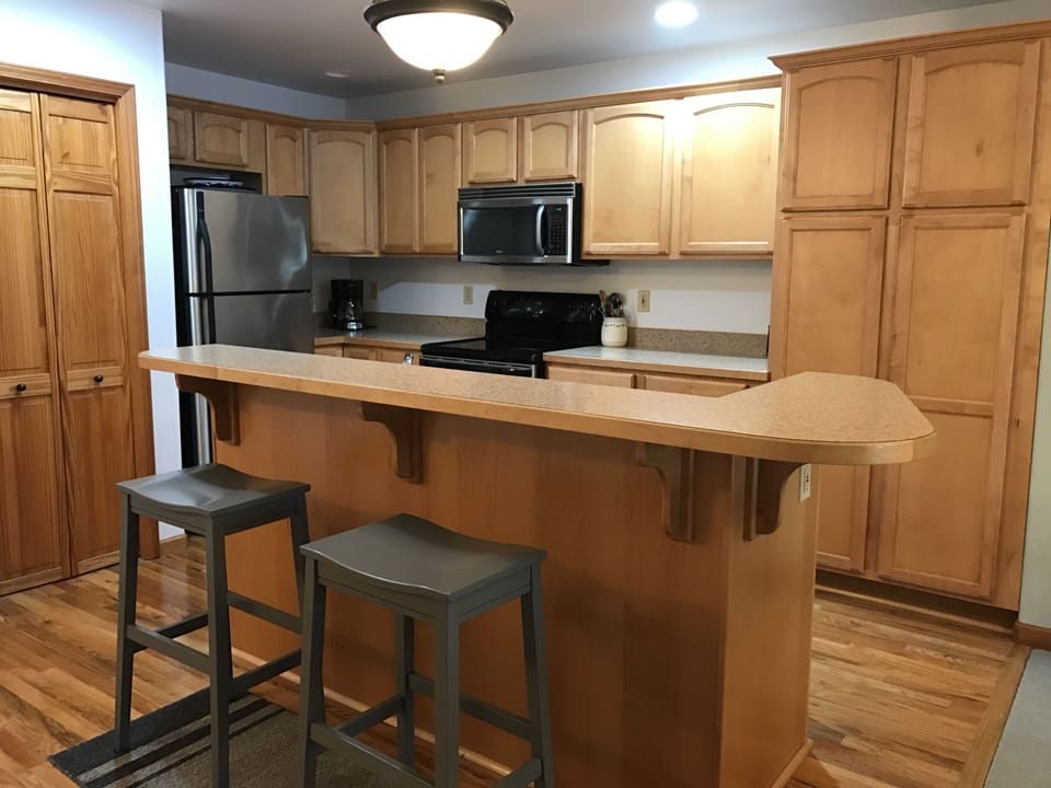 Clean & organized kitchen with seating for two at island.  Plenty of everything.