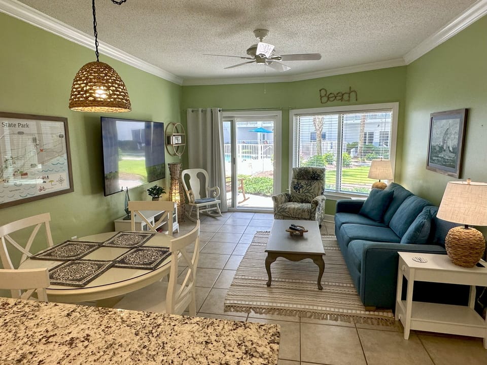 Spacious living room with lots of natural light looking straight out to the pool