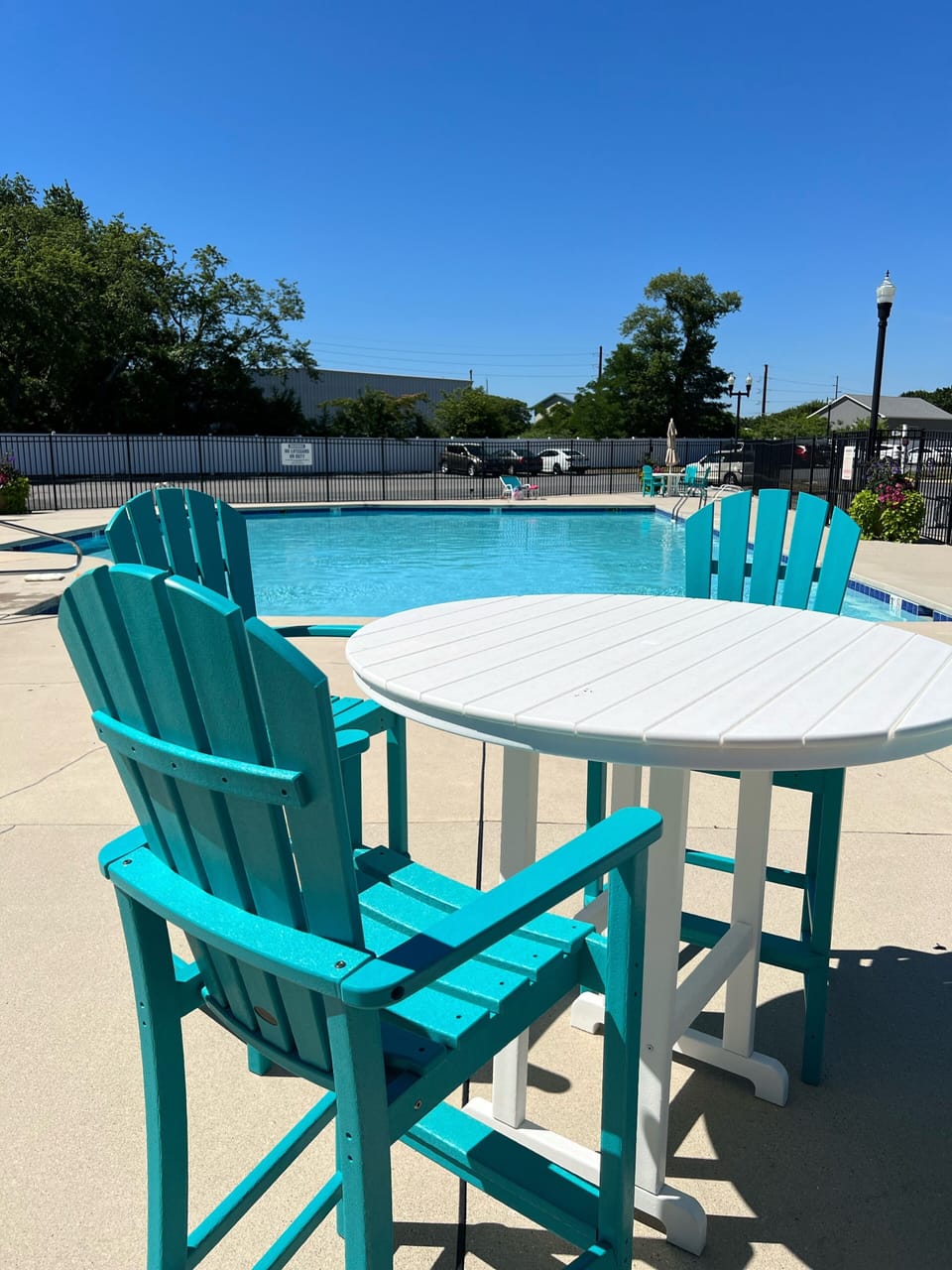 New pool furniture purchased in 2022 and planters by the pool.