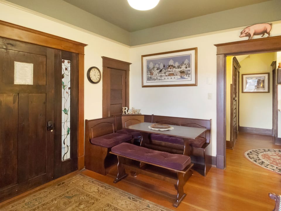 The seating area with bench space, a Smart TV, and chair.