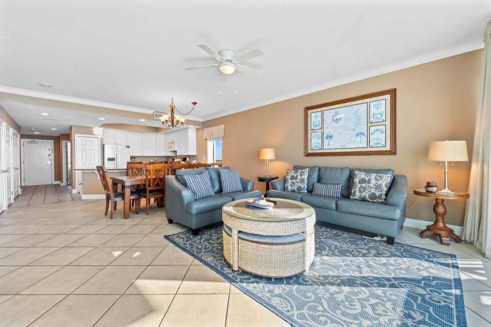 Settle into your stylish living room with plush blue sofas and coastal charm, perfect for relaxing after beach days.