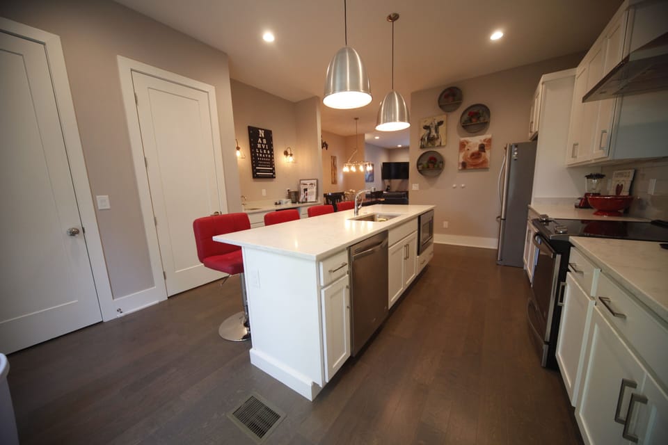 Large open kitchen with lots of counter space, cabinets and bar seating