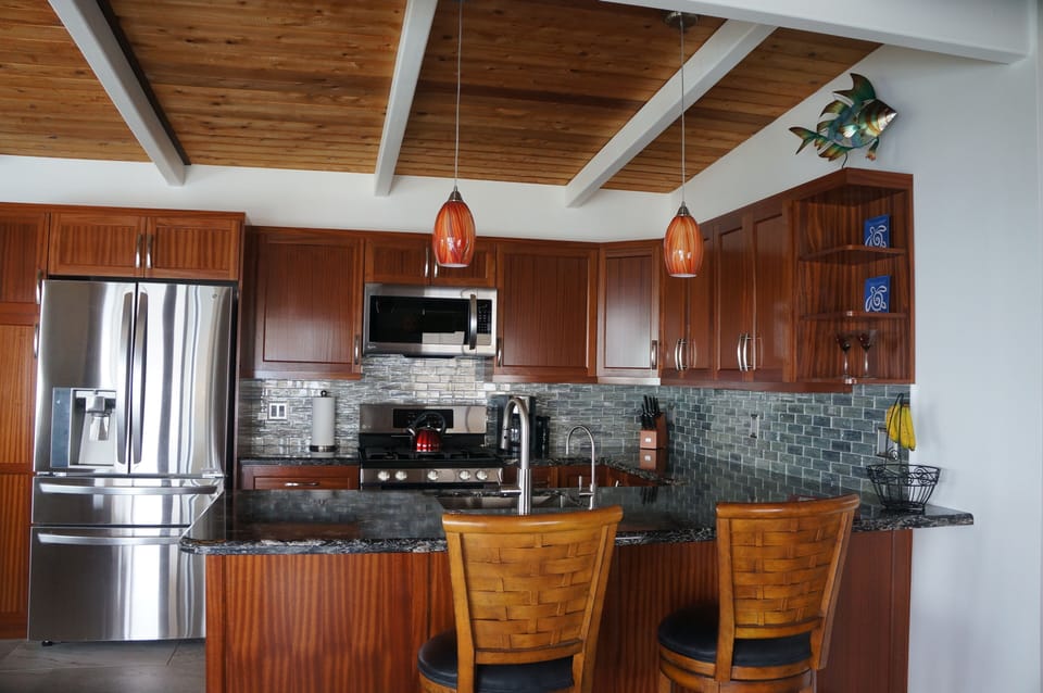 Custom gourmet kitchen with exotic mahogany cabinets