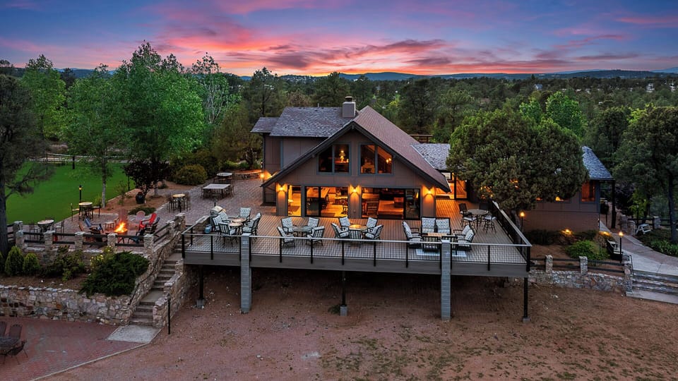 Expansive deck with cozy seating, warm lighting, and beautiful scenic views.