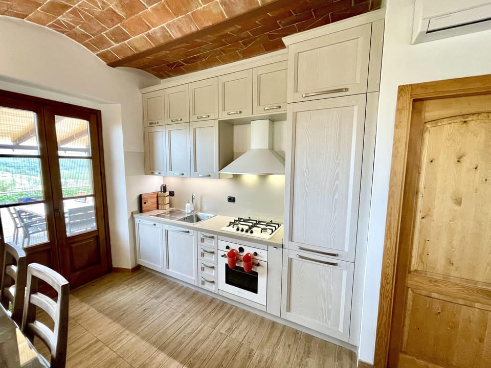 New kitchen leading out to covered outdoor dining.