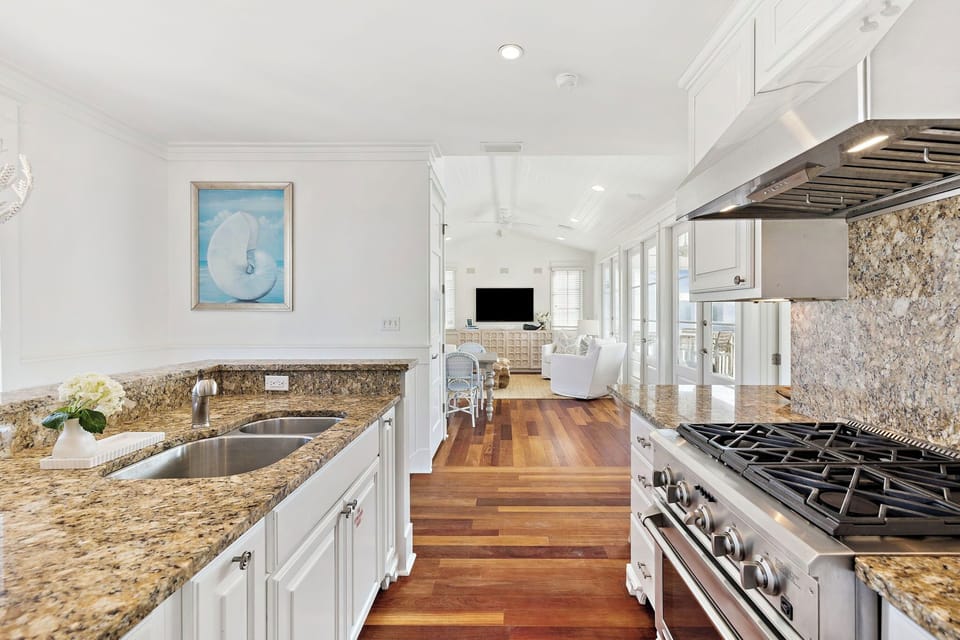 Your gourmet kitchen features granite countertops, premium appliances, and beautiful hardwood floors flowing into the bright living area.