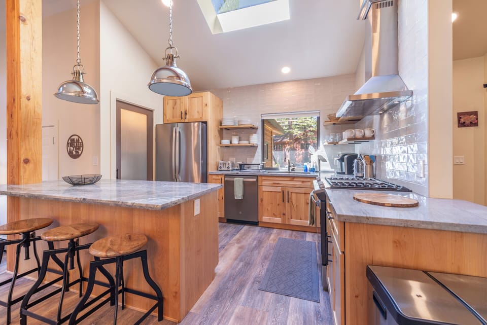 Fully stocked kitchen, with large pantry and vaulted ceiling with skylight.