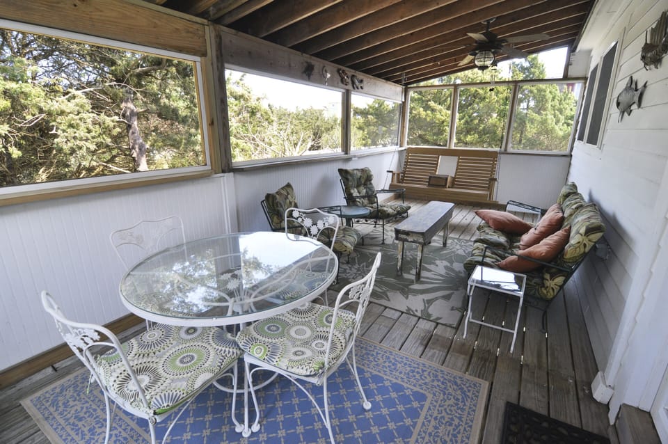 Rear Screened Porch with Seating and Dining Table