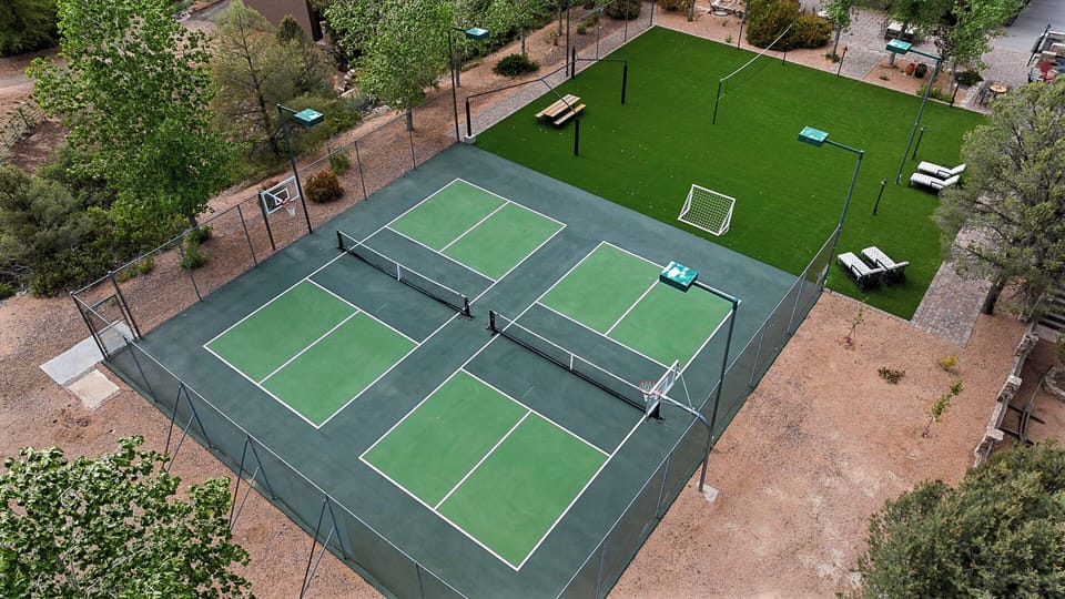Private sports court with pickleball, basketball, volleyball, and turf field.