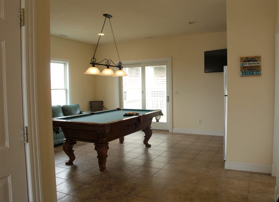 Game Room on lower level with pool table/smart TV/microwave/wetbar/fridge