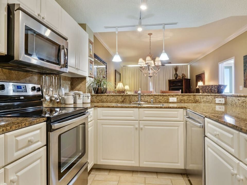 The kitchen is stocked with dishes, cookware, blender, toaster, mixer and more!