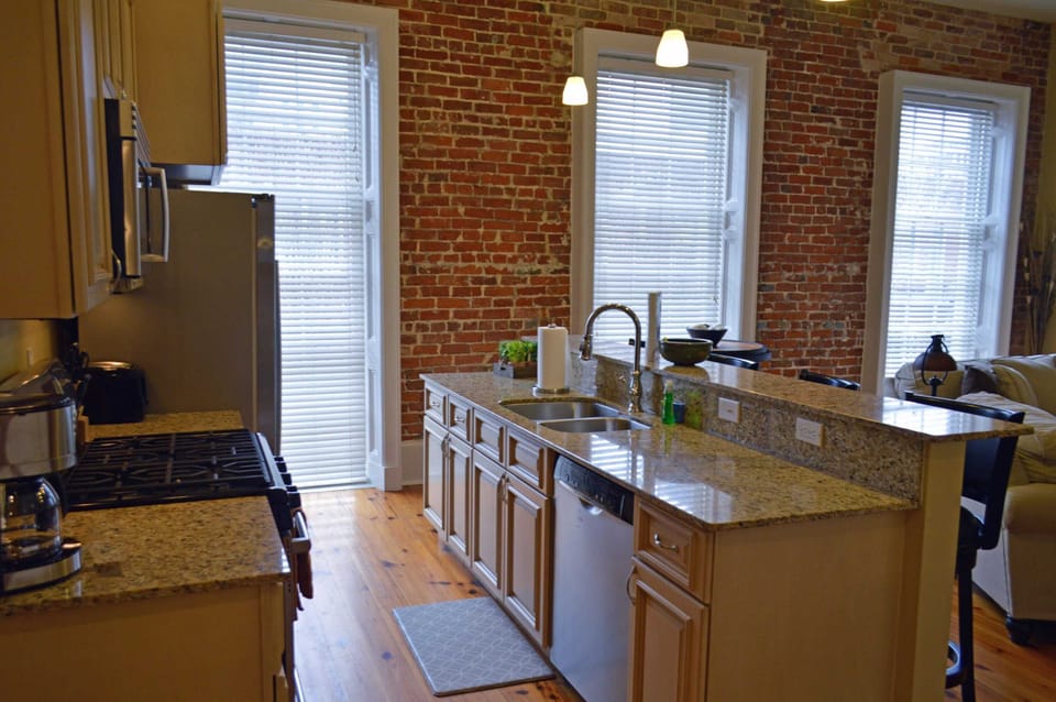 Kitchen island had sink and dishwasher and a breakfast bar with barstools
