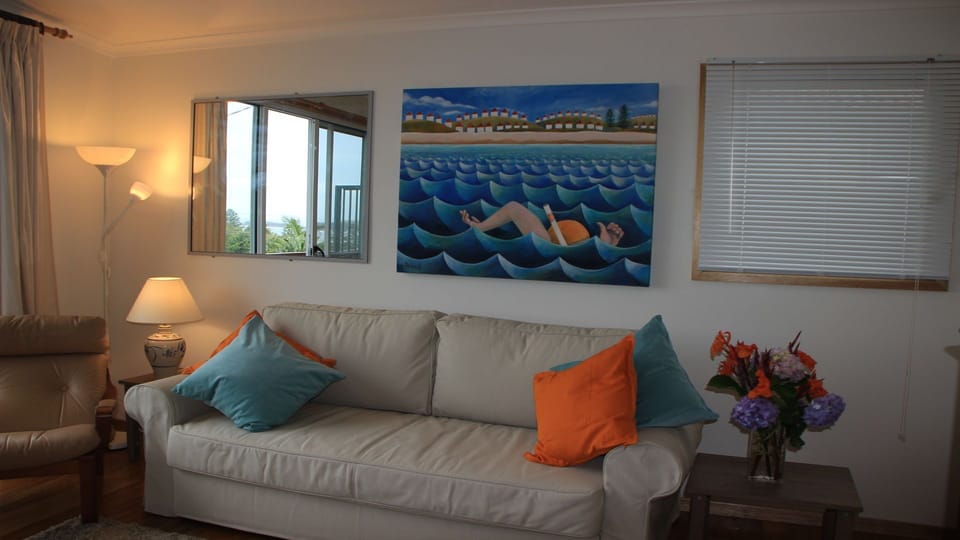 double sofa bed in living room, tv , air con , o/h fan.