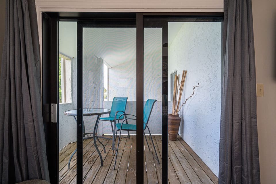 Primary Bedroom - Step out onto the open balcony just off the master bedroom and enjoy the shade and salt air