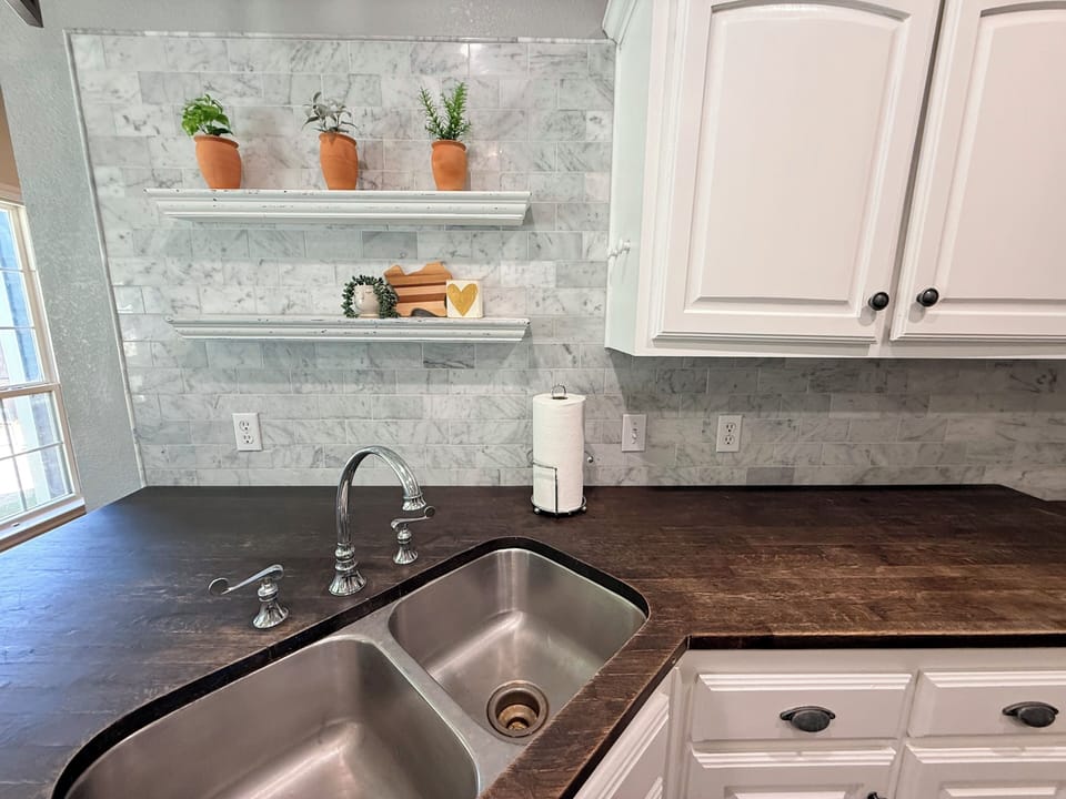 Stainless steel sink, butcher block countertops 