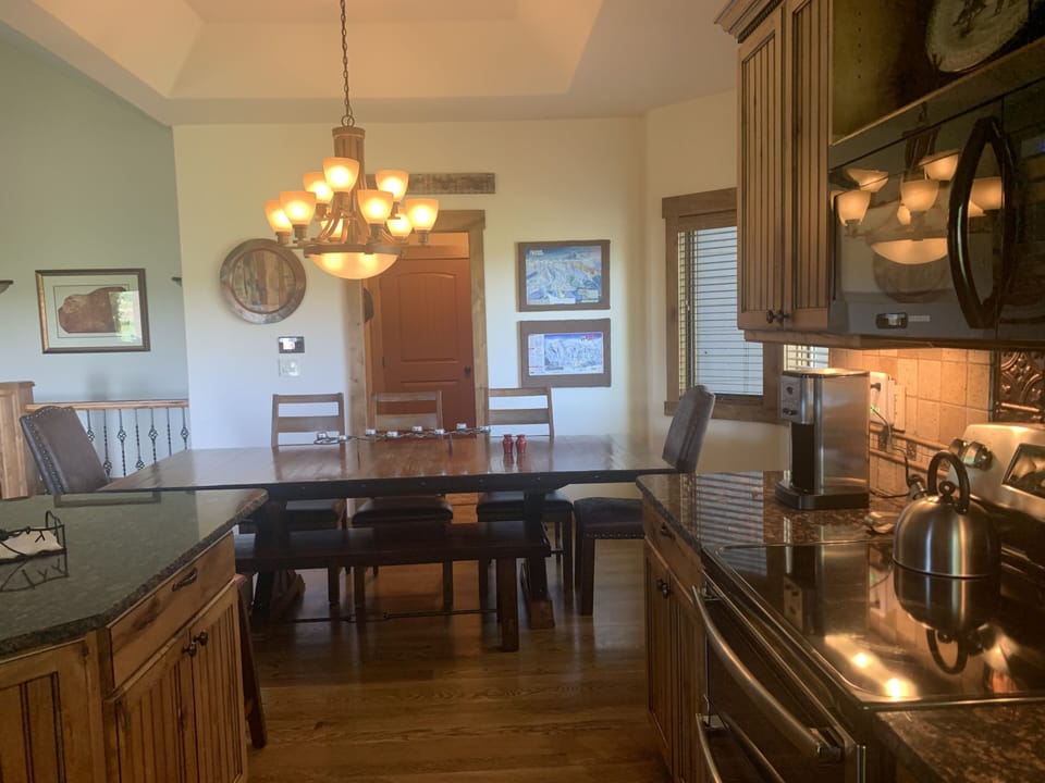 View from kitchen to laundry room & garage. Ski maps on left to plan your day!