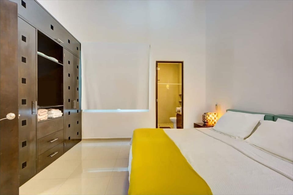 Master bedroom with king size bed, air conditioning and attached bathroom