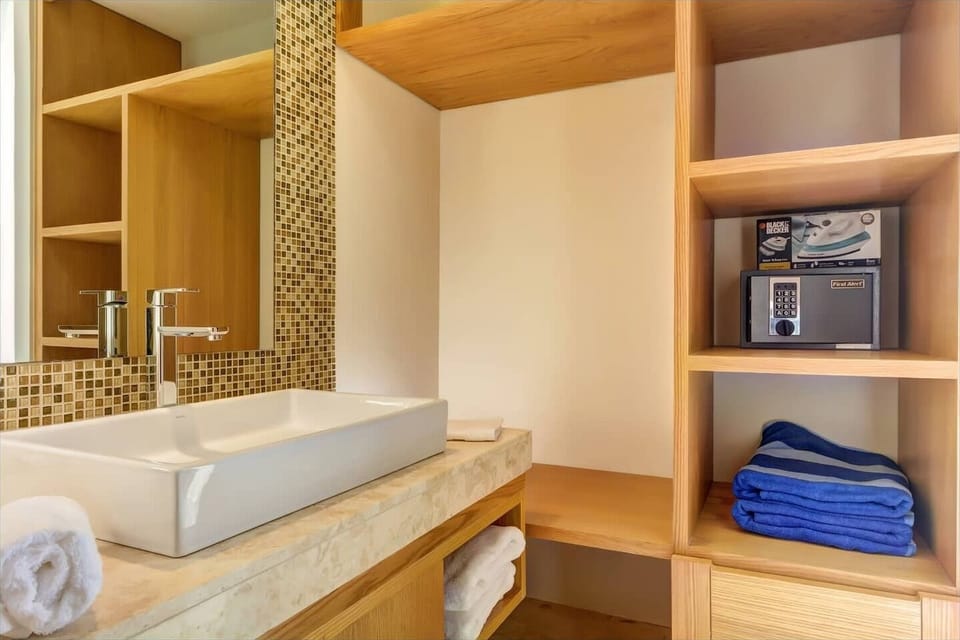 Private master bathroom with closet space and a safe