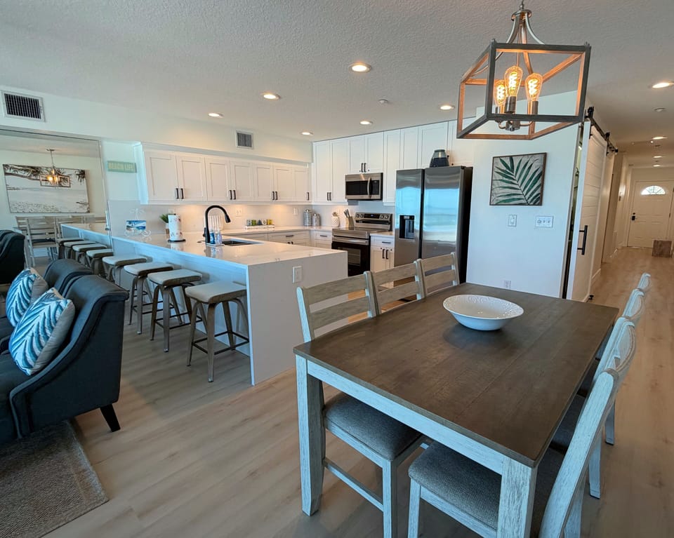 View of the dining table beside the kitchen and living room. Off - View of the dining table beside the kitchen and living room. Off to the right is the front entrance door and the hallway that leads to the bedrooms and bathrooms.