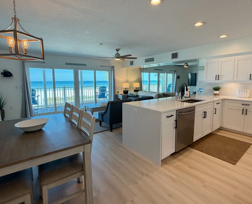 View coming into the main living area of the kitchen, dining roo - View coming into the main living area of the kitchen, dining room, living room all highlighted by a beachfront view of Indian Rocks Beach.