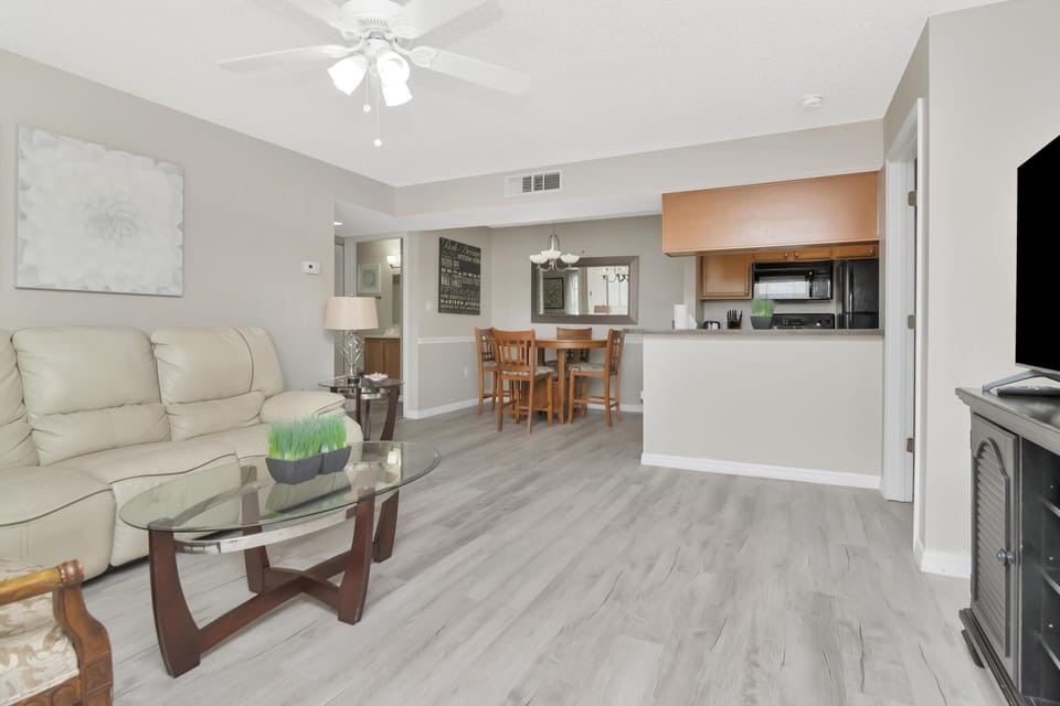 Spacious living room with cozy seating and open kitchen access