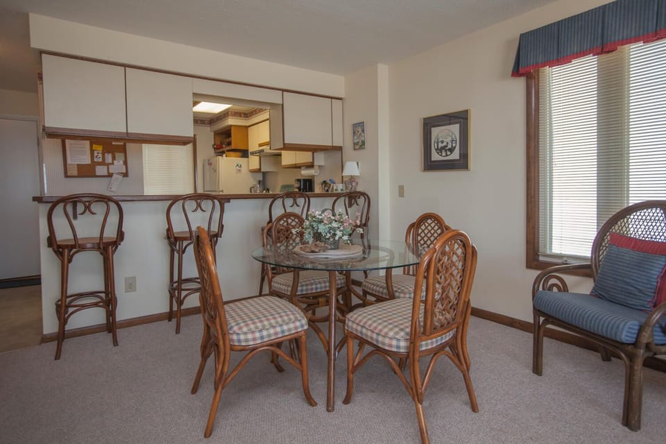 Dining table with seating for four and additional kitchen bar seating