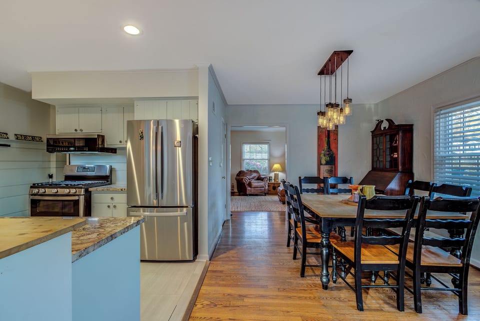 Open space into front living room and large seating of eight at this table