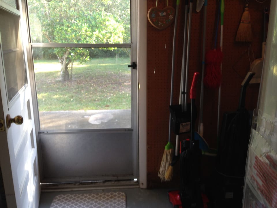 looking out into large back yard, grill out on porch