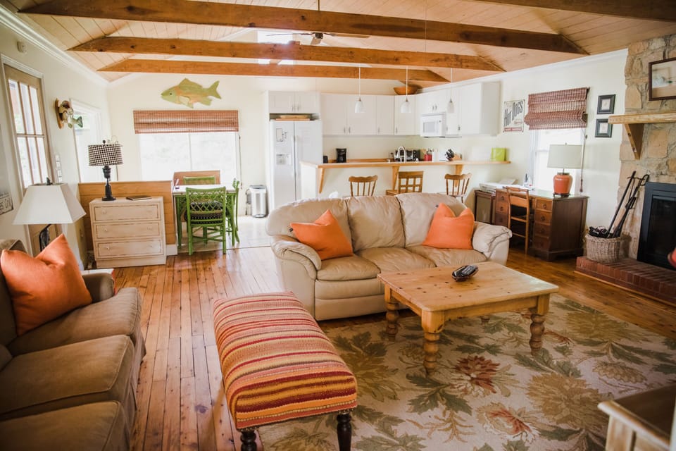 Main floor living and kitchen area. 2 couches, flat screen tv and open kitchen. 