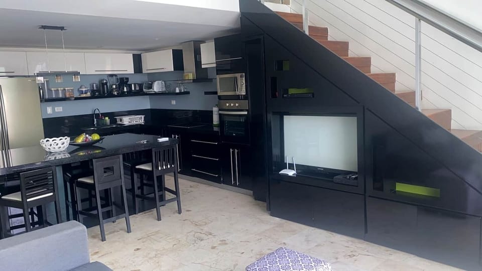 Kitchen and stairs leading to master bedroom.