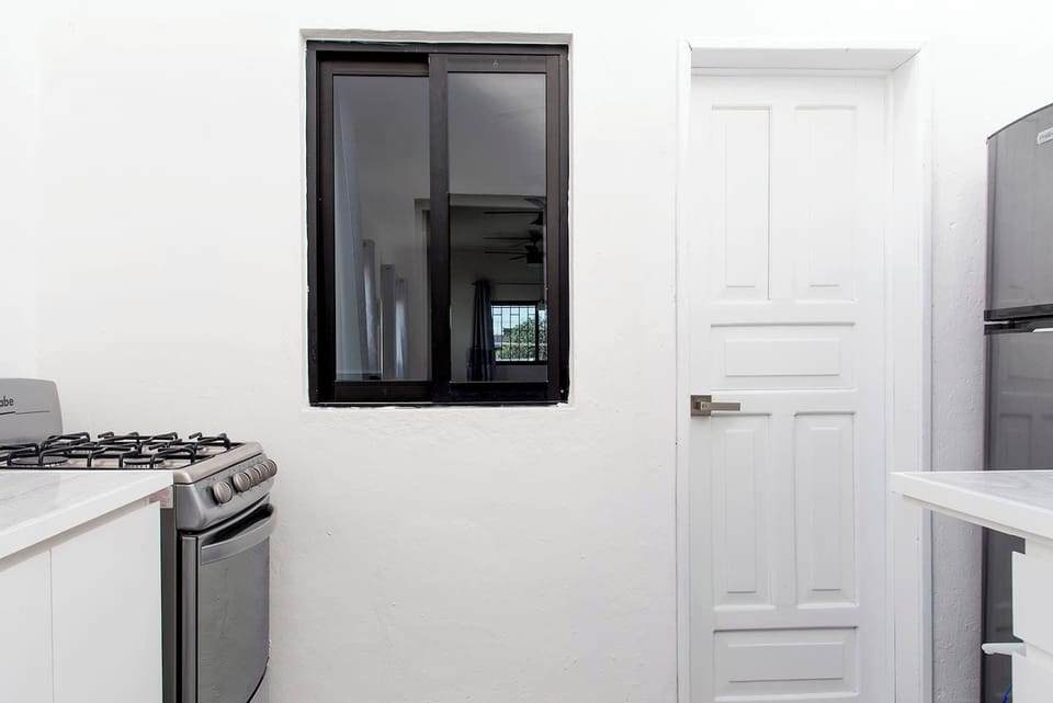 Kitchen with microwave, stove, refrigerator and kitchen supplies