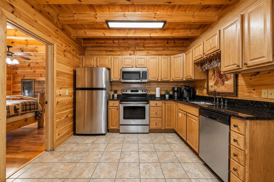 Fully equipped kitchen with granite countertops, stainless appliances, and plenty of space for family meals