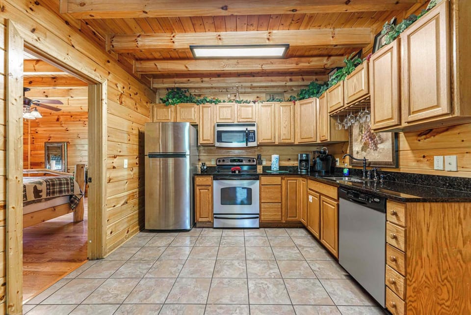 This stylish kitchen showcases premium stainless steel appliances with elegant granite countertops for a clean, modern look