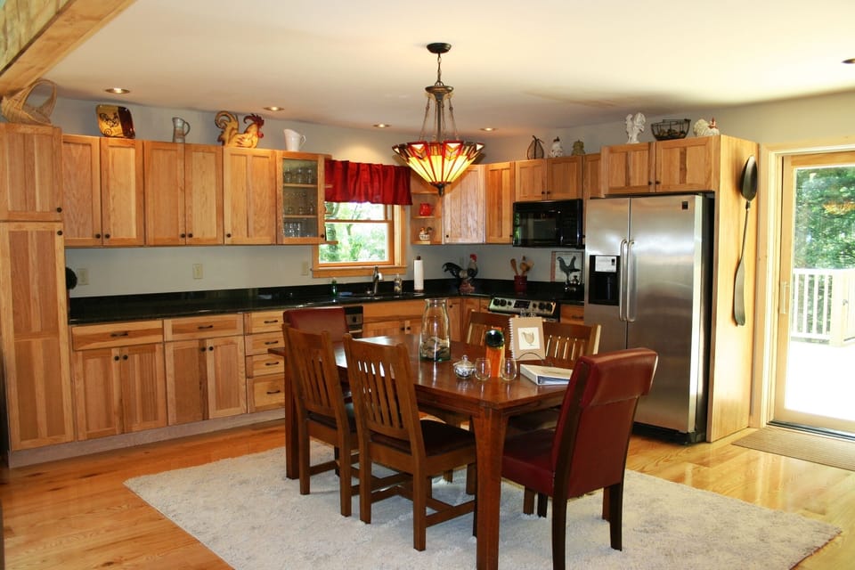 Granite, stainless and hickory kitchen. Stickley heirloom table.