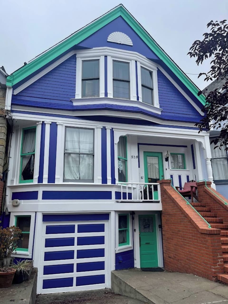 Our turn-of-the century Edwardian home. Your entrance is through the green door on the ground level.