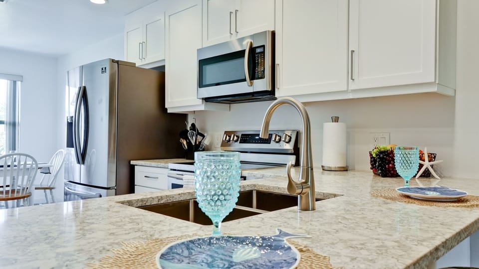 Large kicthen island with bar stools.