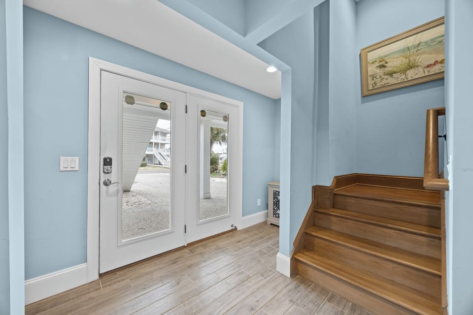 Step into your welcoming foyer with elegant coastal charm and warm wood floors that invite you home.