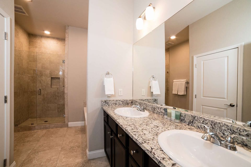 Master bath with dual vanity, soaking tub and tiled walk-in shower