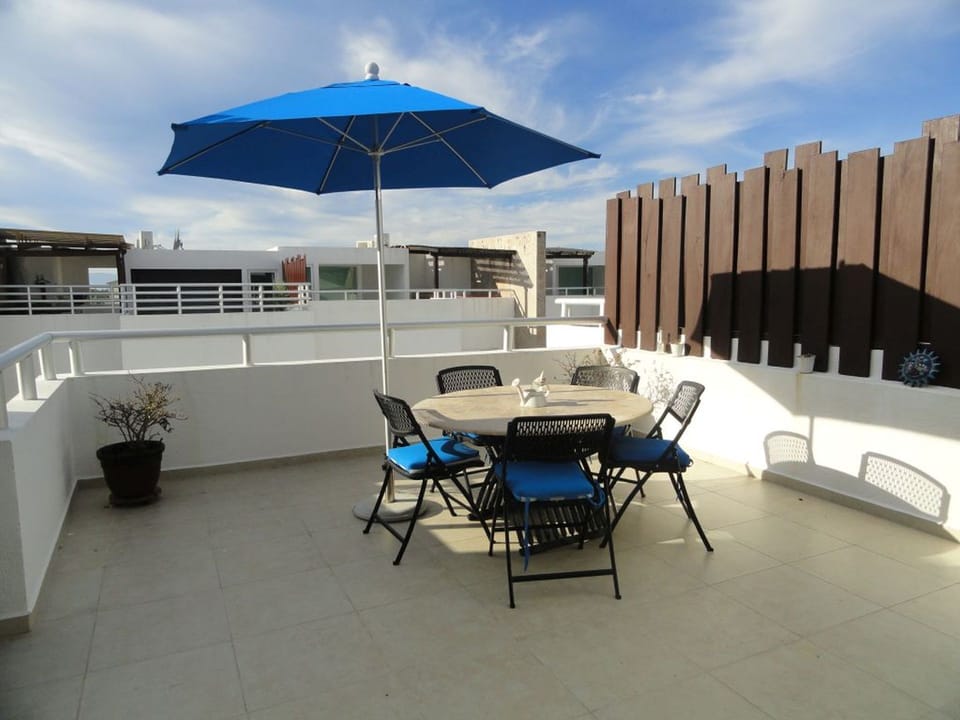 Terrace with seating area and BBQ grill.