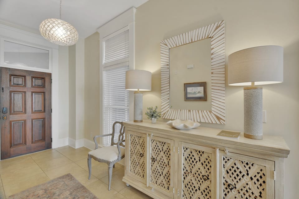 Entryway with High Ceilings - Entry opens to high ceilings, coastal textures, and direct flow toward the bedrooms and main living area.